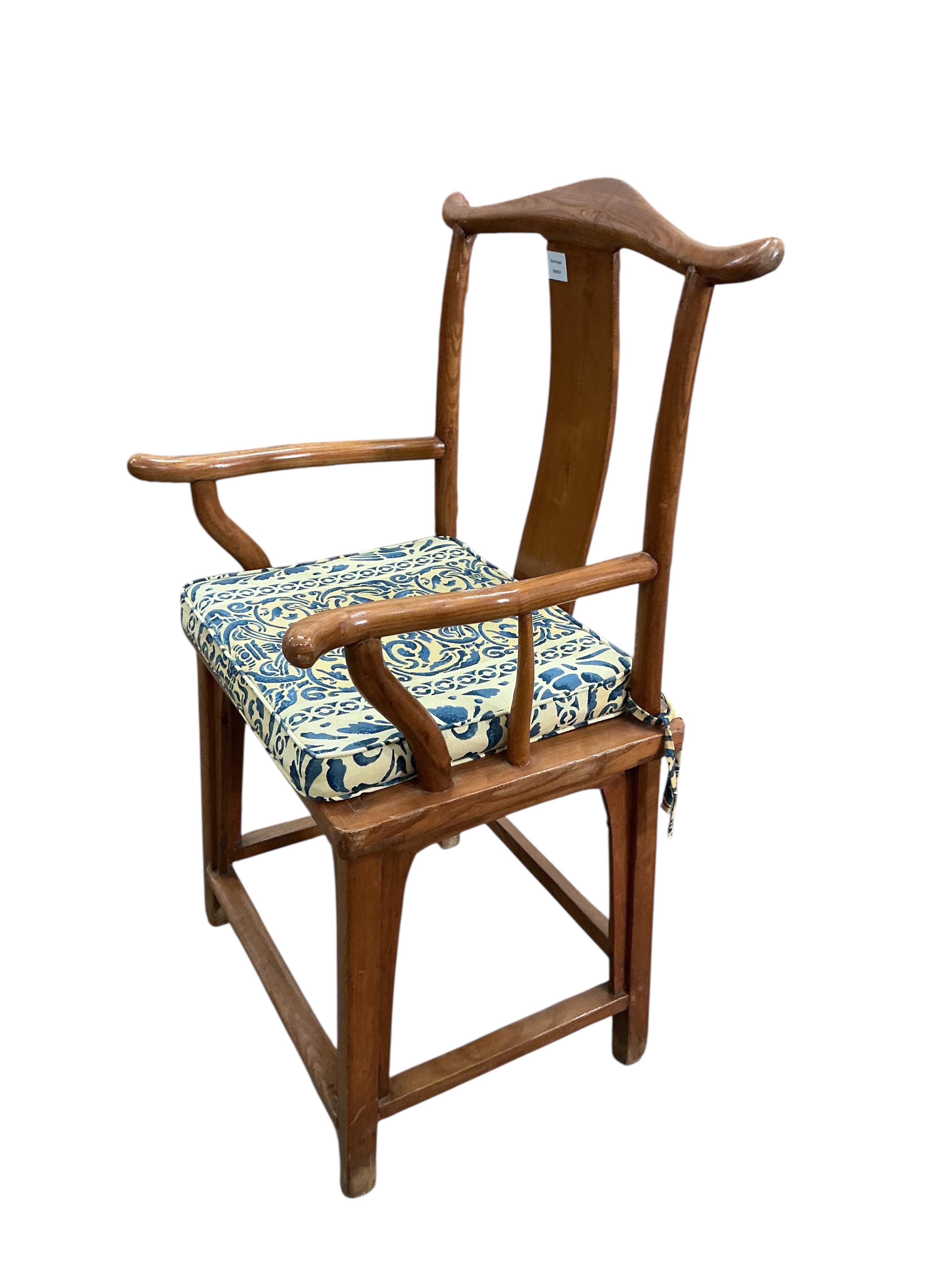 A Chinese elm elbow chair, width 58cm, depth 46cm, height 110cm